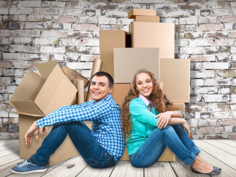 Professional movers handling desks and boxes in a commercial move