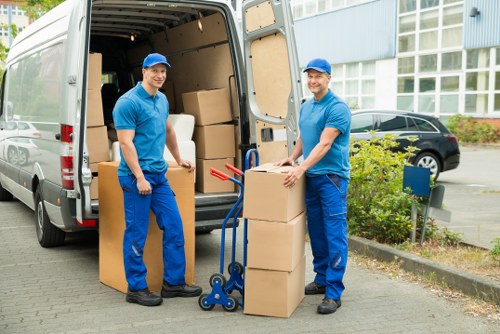 Careful loading of a grand piano into a moving vehicle