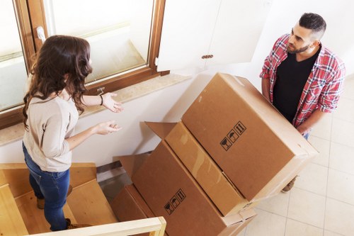 Packed boxes and furniture being loaded into a moving truck